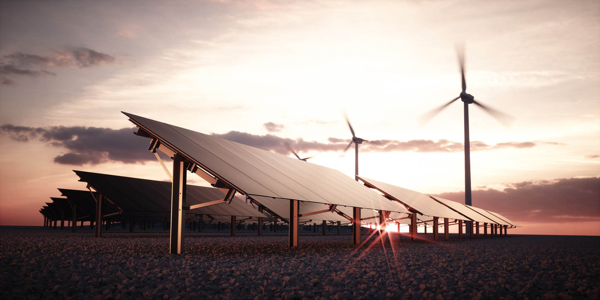 Solar energy infrastructure and wind turbines at sunset